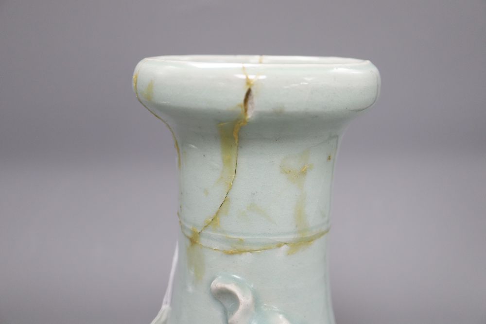 A 17th century Chinese celadon glazed vase, height 26.5cm (a.f) and a pin dish